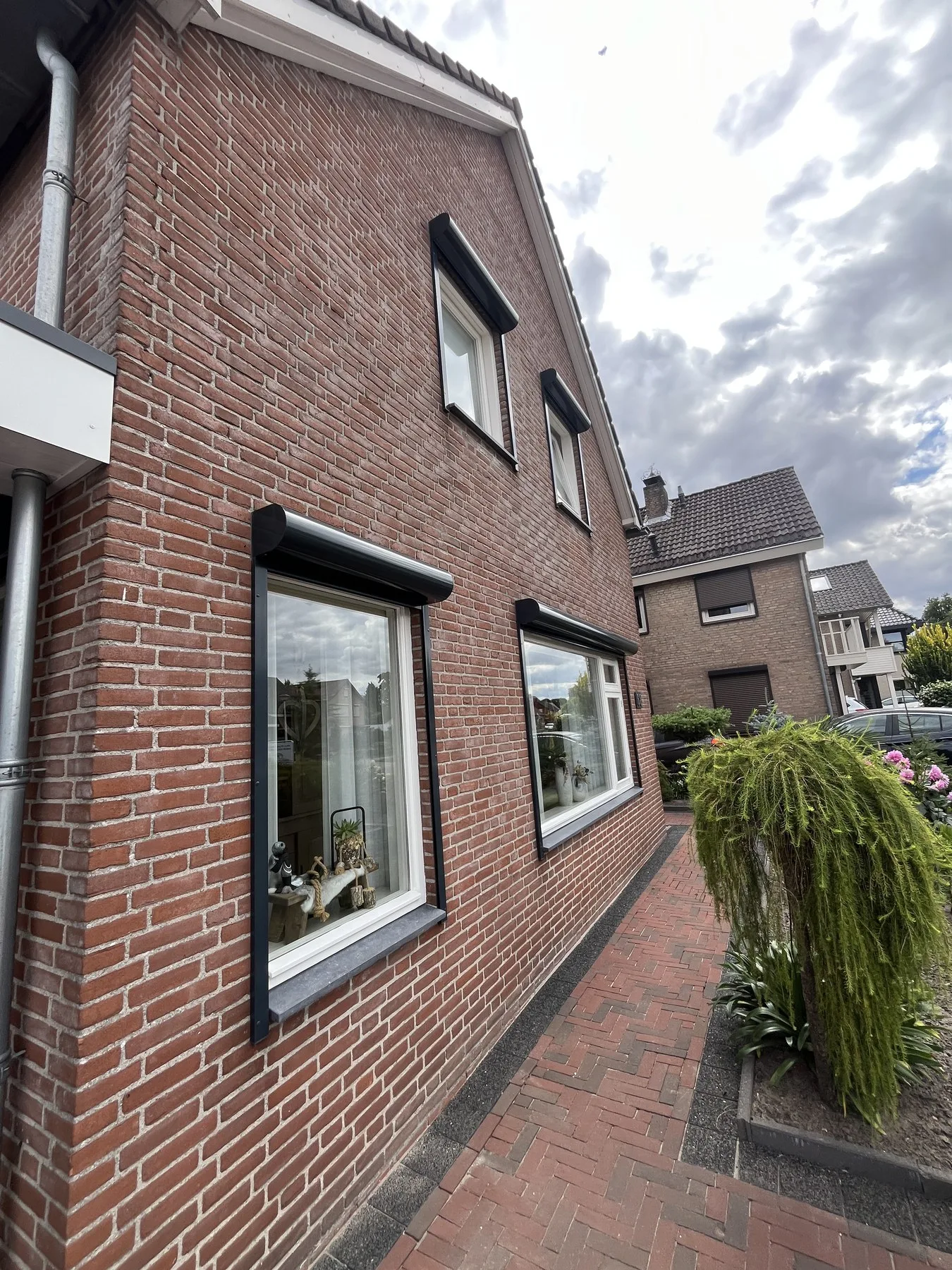 Zijgevel van de woning in Sprundel met nieuwe kunststof kozijnen